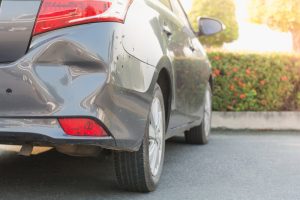 Gray Car with Dents on Rear Bumper for Repair